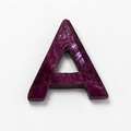 A single uppercase letter A cut from a deep magenta-purple stone, shown on a plain white background.